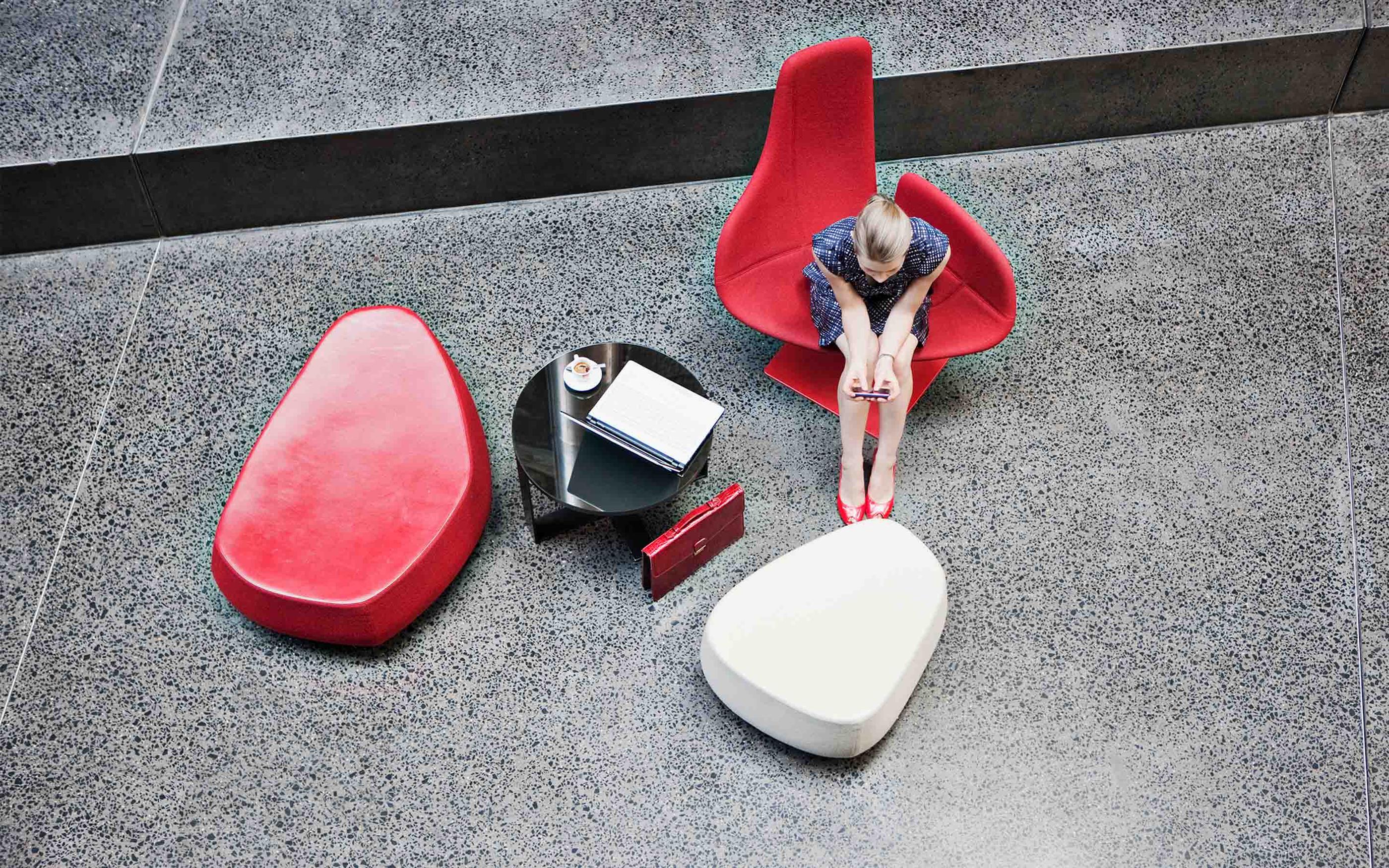 Businesswoman holding cell phone in modern lobby