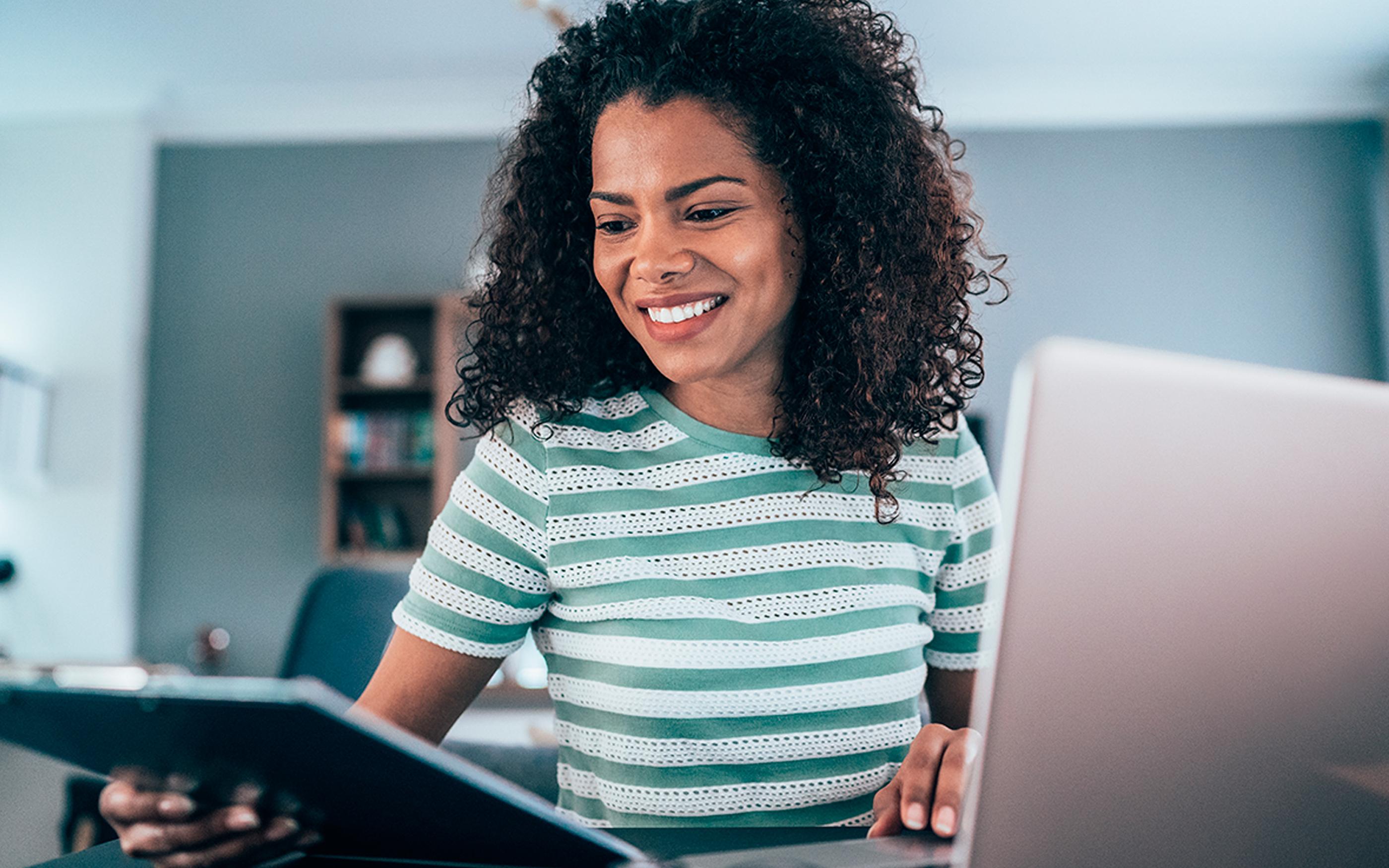 Young woman working from home, using laptop